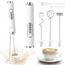 Electric milk frother and accessories, white and silver, on white background with cup of coffee.